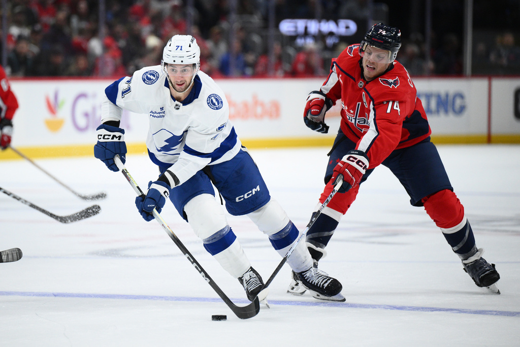 Tampa Bay Lightning center Anthony Cirelli (71) skates with the puck against Washington Capitals defenseman John Carlson (74) during the first period of an NHL hockey game, Tuesday, Oct. 14, 2025, in Washington. (AP Photo/Nick Wass)