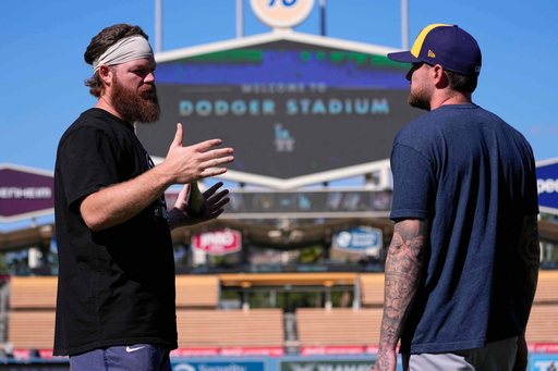 Milwaukee Brewers' Brandon Woodruff, left talks with Brice Turang ahead of Game 3 of baseball's National League Championship Series against the Los Angeles Dodgers, Wednesday, Oct. 15, 2025, in Los Angeles. (AP Photo/Mark J. Terrill) Milwaukee Brewers' Brandon Woodruff, left talks with Brice Turang ahead of Game 3 of baseball's National League Championship Series against the Los Angeles Dodgers, Wednesday, Oct. 15, 2025, in Los Angeles. (AP Photo/Mark J. Terrill)