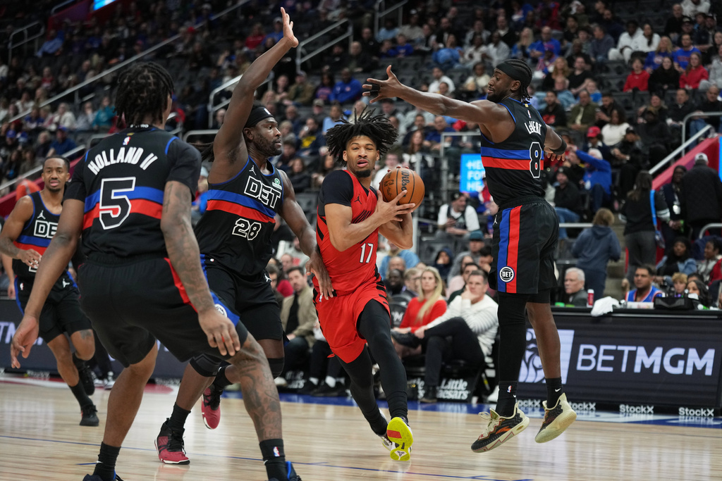 Portland Trail Blazers guard Shaedon Sharpe, second from right, drives against Detroit Pistons forward Ronald Holland II, forward Isaiah Stewart, and guard Caris LeVert, from left, during the first half of an NBA basketball game Friday, Dec. 5, 2025, in Detroit. (AP Photo/Ryan Sun)