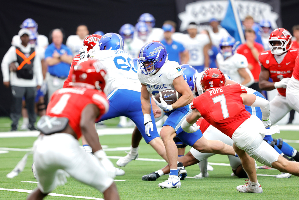 Air Force running back Owen Allen (2) gets past UNLV defensive back Jake Pope (7) and runs for a touchdown during the first half of an NCAA football game Saturday, Oct. 11, 2025, in Las Vegas. (Steve Marcus/Las Vegas Sun via AP)