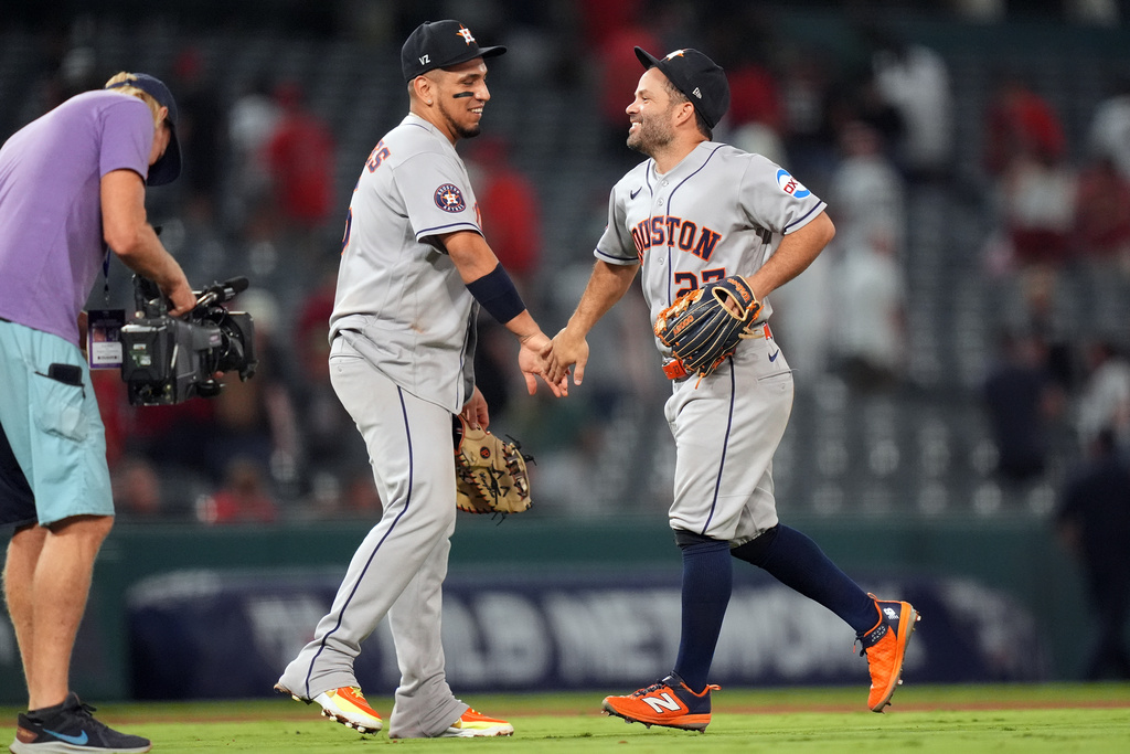 Houston Astros' Jose Altuve (27) and Isaac Paredes (15) celebrate their win over the Los Angeles Angels during a baseball game Monday, July 27, 2026, in Anaheim, Calif. (AP Photo/Scott Strazzante)