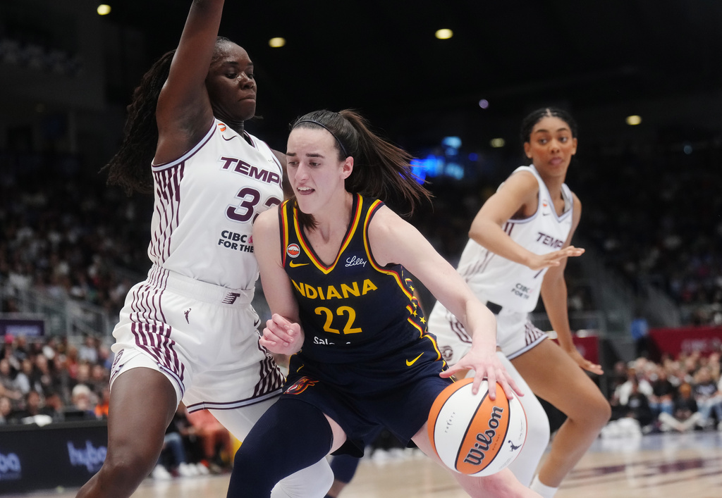 Indiana Fever's Caitlin Clark (22) drives as Toronto Tempo's Ornella Bankole, left, defends during the second half of a WNBA basketball game in Toronto, Friday, Sept. 18, 2026. (Nathan Denette/The Canadian Press via AP)