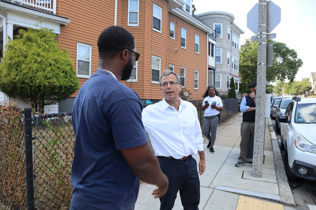 Nonprofit leader and Boston mayoral candidate Josh Kraft, son of Patriots owner Robert Kraft, speaks about his campaign with residents while canvassing on Friday, Sept. 5, 2025, in Dorchester, Mass. (AP Photo/Leah Willingham)