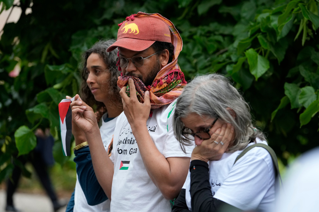 A group of Palestinians gather in front of the main entrance wearing the names of artists who have been killed in Gaza, at the Venice 2026 Biennale Art, Italy, Tuesday, May 5, 2026. (AP Photo/Luca Bruno)