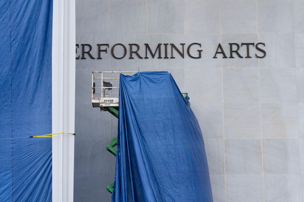 Tarps are installed in front of the sign on the Kennedy Center on Friday, Dec. 19, 2025, in Washington. (AP Photo/Mark Schiefelbein)