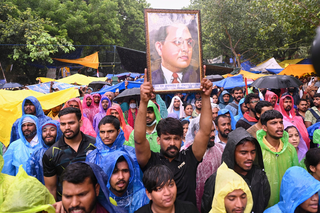A protester holds up a portrait of Bhimrao Ramji Ambedkar, the chief architect of the Indian Constitution, during a demonstration demanding educational reforms as part of the Cockroach Janta Party's ongoing protest movement in New Delhi, India, Friday, July 24, 2026. (AP Photo/Vipin)