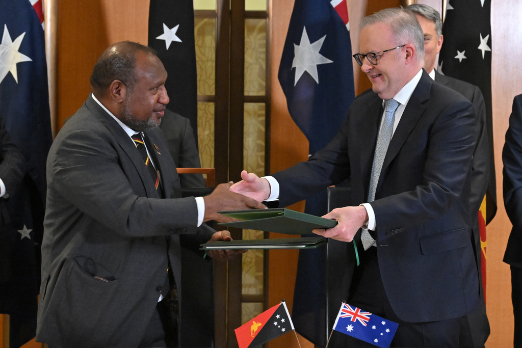 Australia's Prime Minister Anthony Albanese, right, and Papua New Guinea's Prime Minister James Marape sign a defense treaty at Parliament House in Canberra, Australia, Monday, Oct. 6, 2025. (Mick Tsikas/AAP Image via AP)