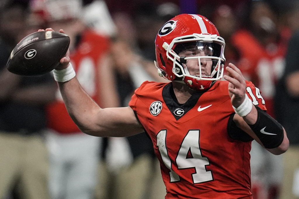FILE - Georgia quarterback Gunner Stockton (14) throws a pass during the second half of the Southeastern Conference championship NCAA college football game against Texas, Saturday, Dec. 7, 2024, in Atlanta. (AP Photo/Mike Stewart, File)