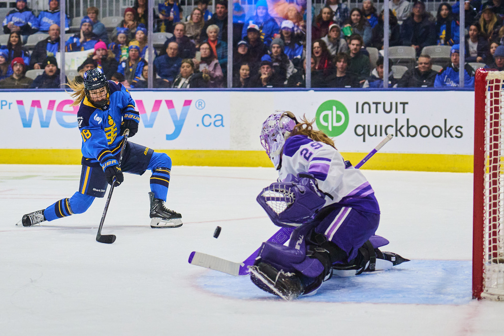Toronto Sceptres' Jesse Compher (18) shoots on Minnesota Frost goaltender Nicole Hensley (29) during second period PWHL hockey action in Toronto, on Tuesday, Dec. 30, 2025. (Sammy Kogan/The Canadian Press via AP)