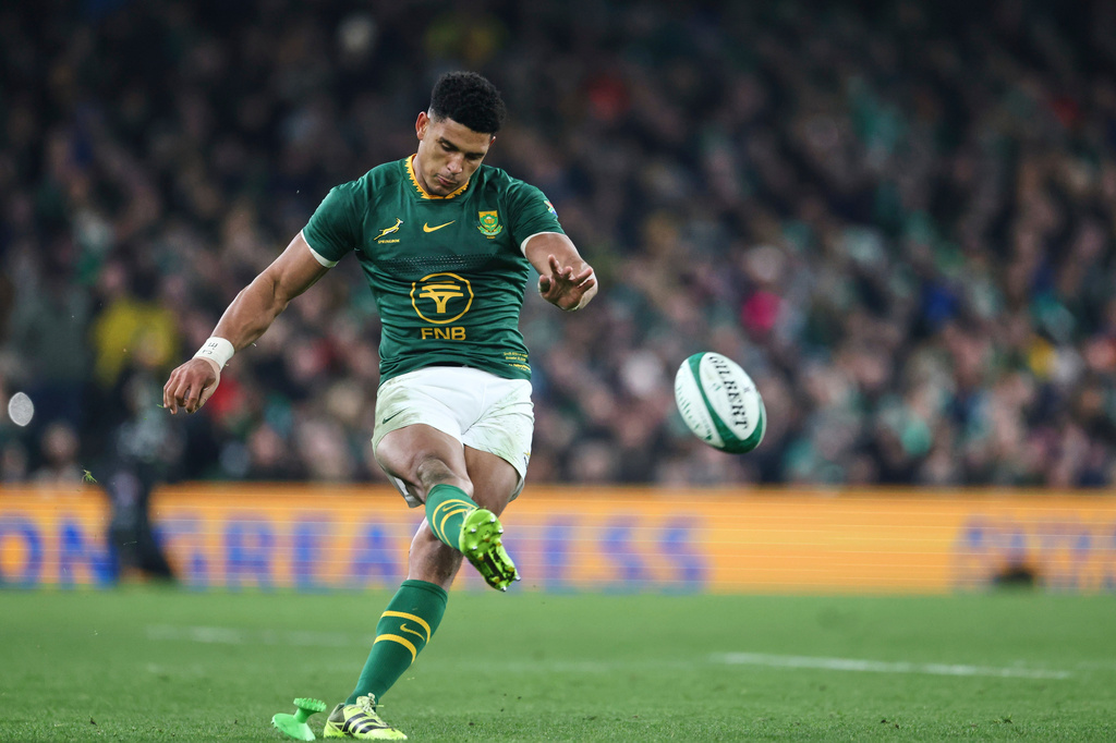 FILE - South Africa's Sacha Feinberg-Mngomezulu kicks a ball to score a conversion during the rugby union Nations Series match between Ireland and South Africa in Dublin, Nov. 22, 2025. (AP Photo/Peter Morrison, File)