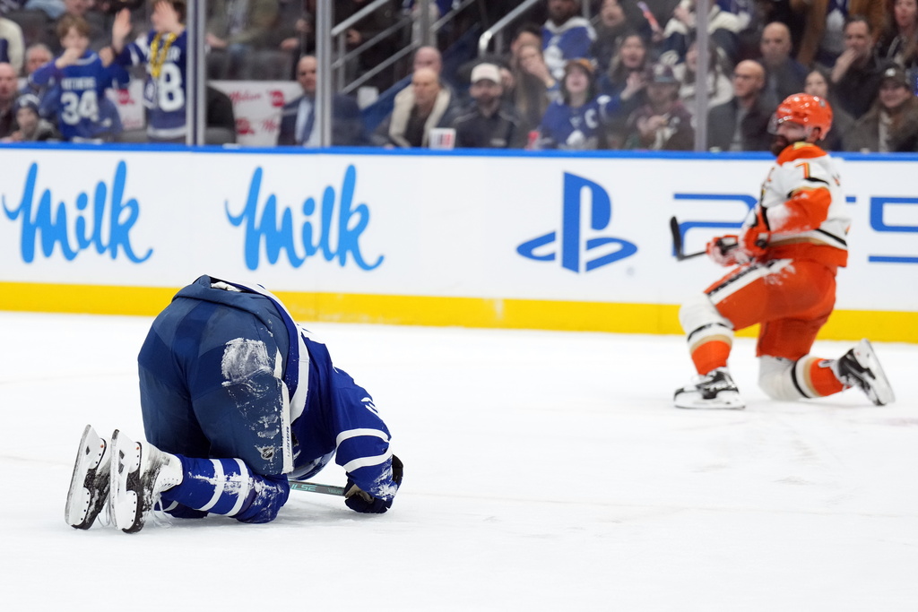Toronto Maple Leafs Auston Matthews, left, is injured by Anaheim Ducks Radko Gudas during the second period of an NHL hockey game in Toronto, Thursday, March 12, 2026. (Nathan Denette/The Canadian Press via AP)
