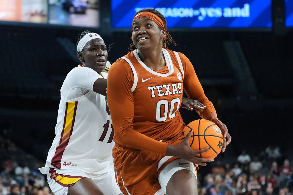 Texas center Kyla Oldacre (00) drives past South Carolina center Madina Okot (11) during the second half of an NCAA college basketball game in the Players Era tournament in Las Vegas, Thursday, Nov. 27, 2025. (AP Photo/Eric Gay)