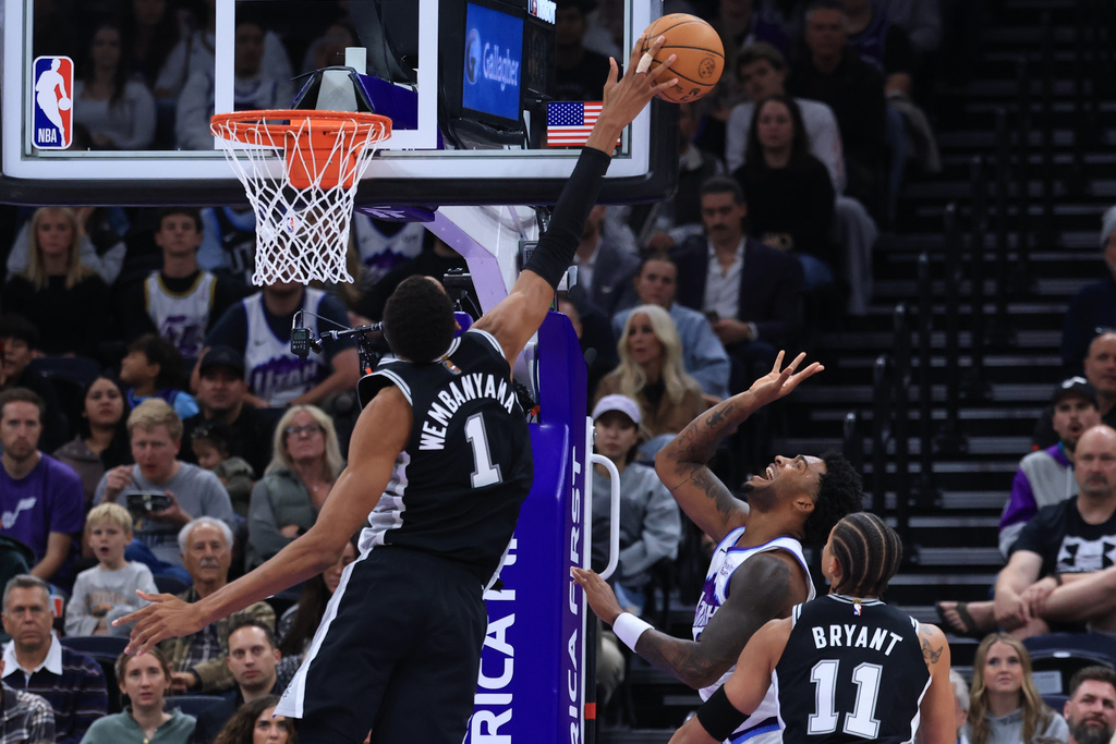San Antonio Spurs forward Victor Wembanyama (1) blocks the shot of Utah Jazz forward Brice Sensabaugh, bottom middle, during the first half of an NBA basketball game, Wednesday, Oct. 28, 2026, in Salt Lake City. (AP Photo/Rob Gray)