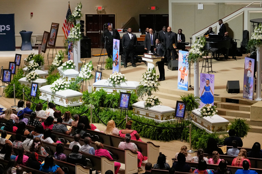 People listen during funeral services for the eight children who were killed during a mass shooting last month, Saturday, May 9, 2026, at the Summer Grove Baptist Church in Shreveport, La. (AP Photo/Gerald Herbert)