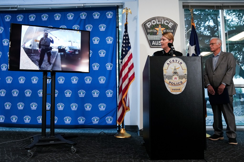 Austin Police Chief Lisa Davis, left, and Mayor Kirk Watson watch as footage from a body-worn camera is played during a news conference at the Austin Public Safety Headquarters, Tuesday, Sept. 22, 2026, providing an update after an ICE agent shot and wounded Wilber Rafael Garcés Pérez in Austin, Texas, Sunday. (Sara Diggins/The San Antonio Express-News via AP)