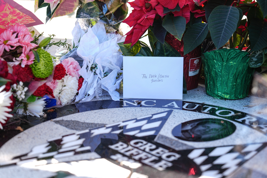 Flowers and cards are displayed at the NC Auto Racing Walk of Fame for Greg Biffle, Friday, Dec. 19, 2025, in Mooresville, N.C. (AP Photo/Matt Kelley)