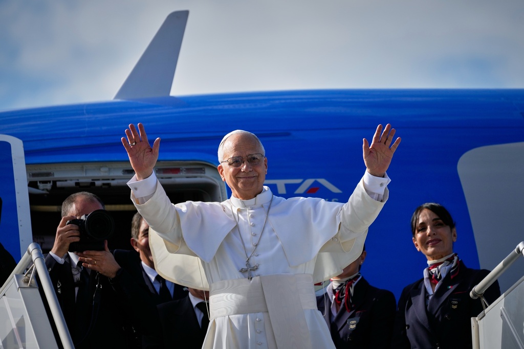 Pope Leo XIV waves as he boards a flight back to the Vatican after his visit to Lebanon at Beirut International Airport in Beirut, Lebanon, Tuesday, Dec. 2, 2025. (AP Photo/Hussein Malla)