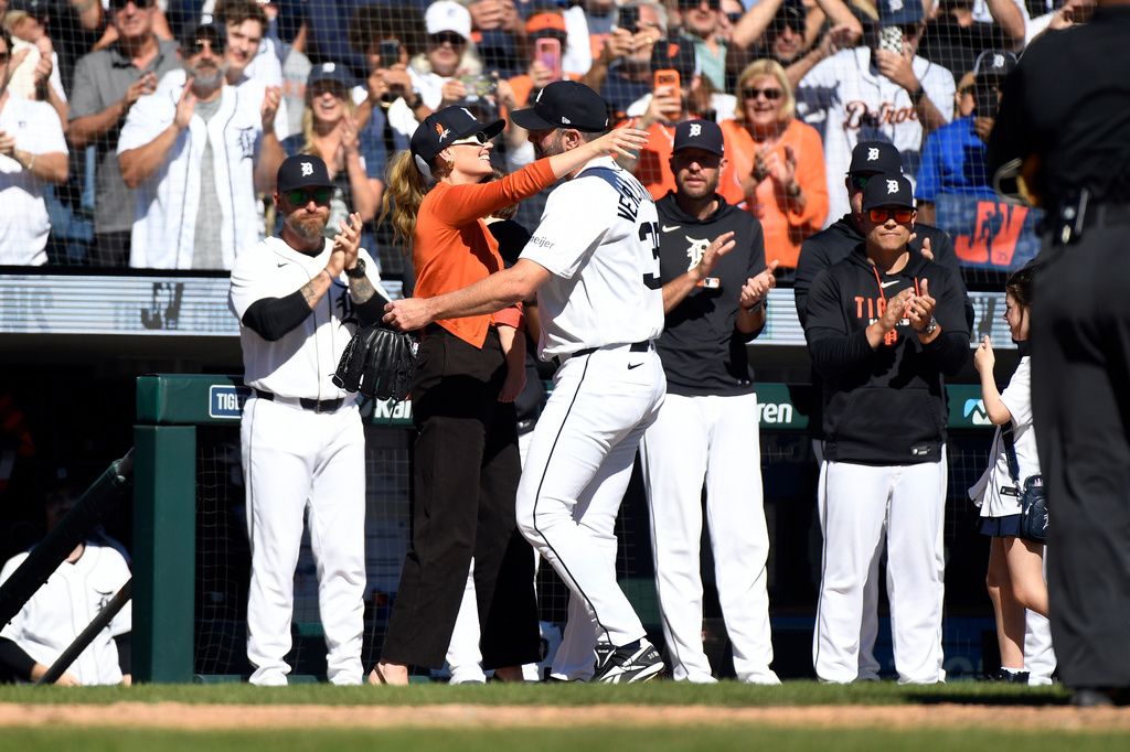 Kate Upton, left foreground, hugs her husband, Detroit Tigers starting pitcher Justin Verlander, after he was taken out of the game during the sixth inning of a baseball game against the Pittsburgh Pirates, Saturday, Sept. 26, 2026, in Detroit. (AP Photo/Jose Juarez)