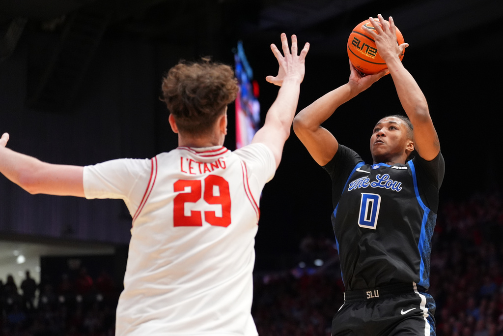 Saint Louis' Kellen Thames (0), right, rises for shot as Dayton's Amael L'etang (29), left, defends during the first half of an NCAA college basketball game, Tuesday, Feb. 24, 2026, in Dayton, Ohio. (AP Photo/Kareem Elgazzar)