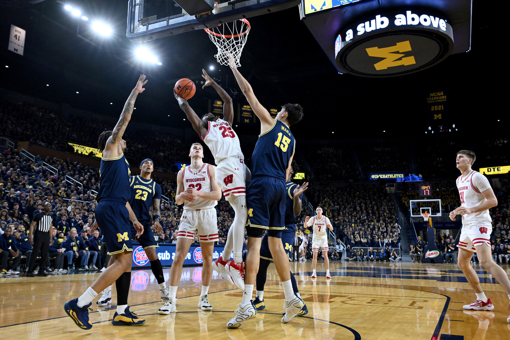 Wisconsinb guard John Blackwell (25) shoots the ball over Michigan center Aday Mara (15) in the first half of an NCAA college basketball game in Ann Arbor, Mich., Saturday, Jan. 10, 2026. (AP Photo/Lon Horwedel)