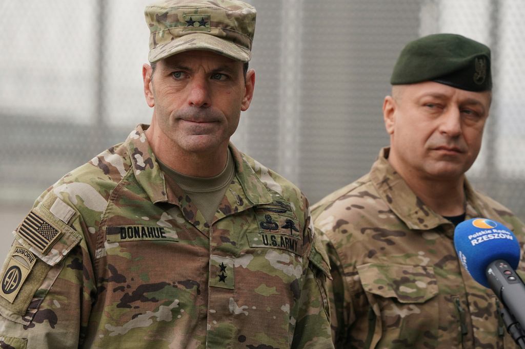 FILE - U.S. Army General Christopher Donahue, left, commanding general of the 82nd Airborne Division, and Polish General Wojciech Marchwica speak to journalists after unloading vehicles from a transport plane arriving from Fort Bragg at the Rzeszow-Jasionka airport in southeastern Poland, on Feb. 6, 2022. (AP Photo, File)