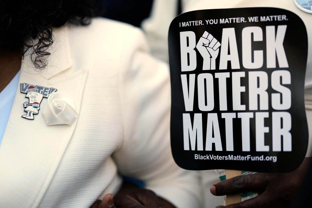 A vote pin is seen on the lapel of Sen. Raumesh Akbari, D-Memphis, during a rally after a special session of the state legislature to redraw U.S. Congressional voting maps Thursday, May 7, 2026, in Nashville, Tenn. (AP Photo/George Walker IV)