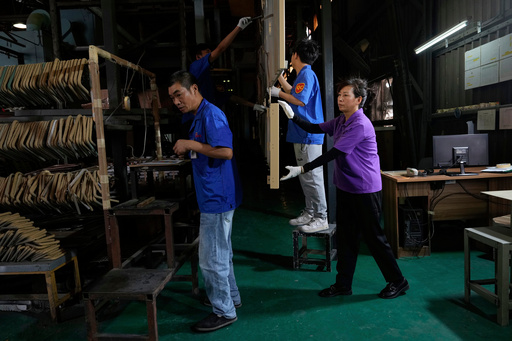 FILE - Workers check aluminum panels produced at a factory of Kam Pin Industrial (HK) Ltd, in Dongguan city in southern China's Guangdong province April 17, 2025. (AP Photo/Ng Han Guan, File) FILE - Workers check aluminum panels produced at a factory of Kam Pin Industrial (HK) Ltd, in Dongguan city in southern China's Guangdong province April 17, 2025. (AP Photo/Ng Han Guan, File)