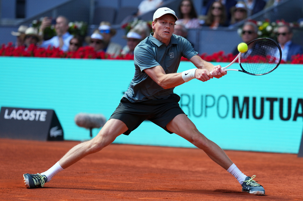 Italy's Jannik Sinner returns the ball to France's Arthur Fils during their men's singles semifinal match at the Madrid Open tennis tournament in Madrid, Spain, Friday, May 1, 2026. (AP Photo/Manu Fernandez)