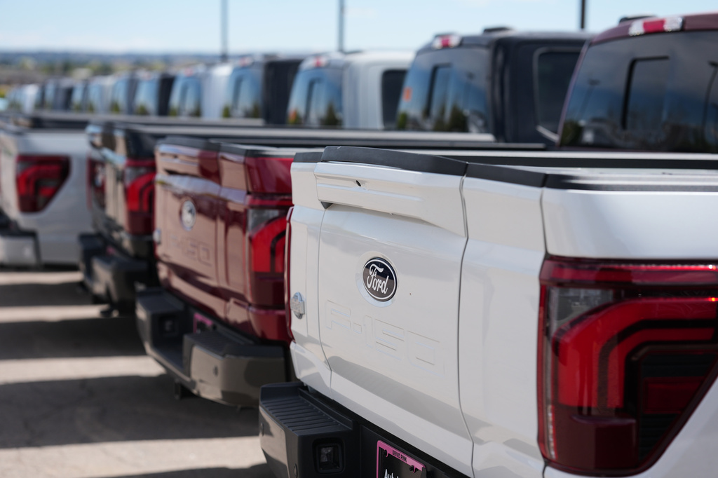 FILE - Unsold 2026 F-150 pickup trucks sit in a long line outside a Ford dealership on April 12, 2026, in Centennial, Colo. (AP Photo/David Zalubowski, File)
