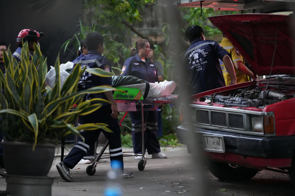 Rescuers wheel a body from the home of a student who shot his grandparents and several other people Friday in Thailand's Nonthaburi province, Friday, Aug. 7, 2026. (AP Photo/Sakchai Lalit)