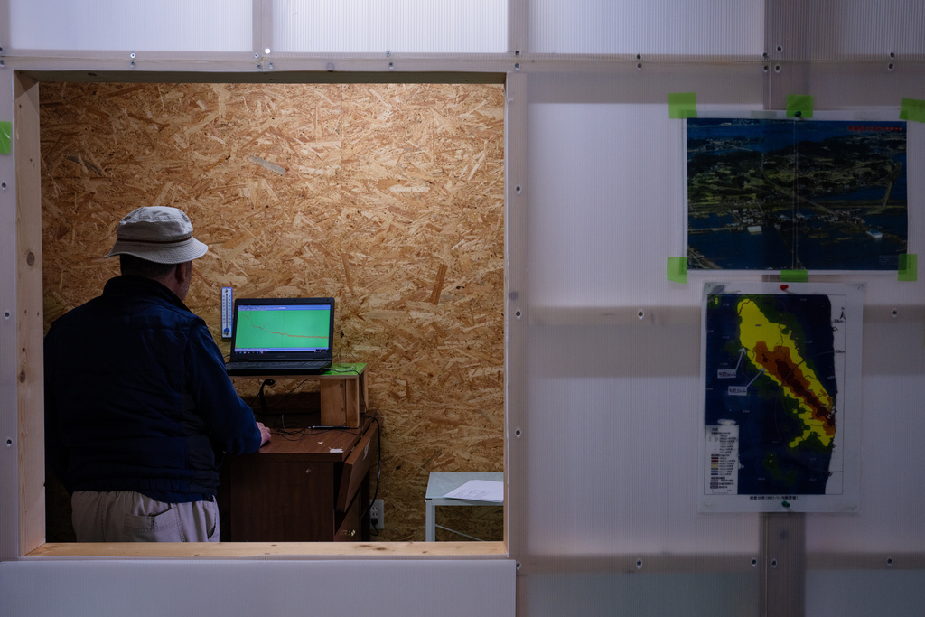 Yukio Shirahige reads the results after measuring a sample at a residents' radiation monitoring lab in Odaka, Friday, Feb. 13, 2026. (AP Photo/Louise Delmotte)