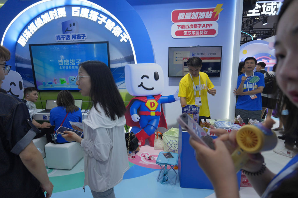 Visitors at the booth for Baidu's AI Agent Dumate during the World AI Conference in Shanghai, China on July 17, 2026. (AP Photo/Ng Han Guan)