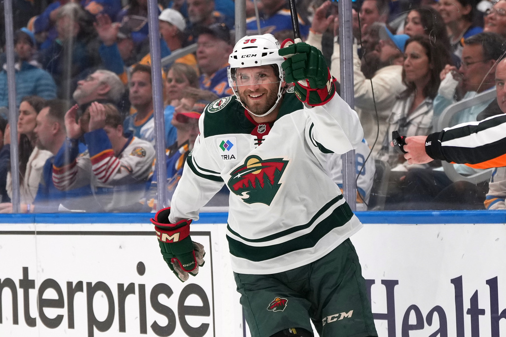 Minnesota Wild's Ryan Hartman celebrates after scoring during the first period of an NHL hockey game against the St. Louis Blues Thursday, Oct. 9, 2025, in St. Louis. (AP Photo/Jeff Roberson)
