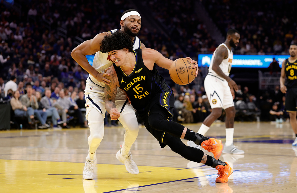 Golden State Warriors forward Gui Santos (15) drives in against Denver Nuggets forward/guard Bruce Brown, left, during the first half of an NBA basketball game, Sunday, Feb. 22, 2026, in San Francisco. (AP Photo/Kelley L Cox)
