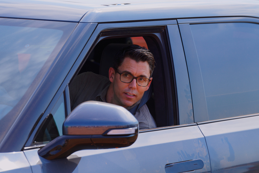 Rivian founder and CEO RJ Scaringe looks out the window of a Rivian R1S after a groundbreaking ceremony at the electric vehicle's future plant outside of Social Circle, Ga, Tuesday, Sept. 16, 2025. (Matthew Pearson/WABE via AP)