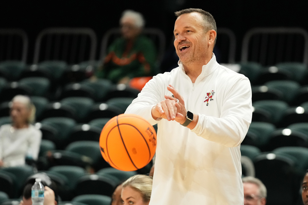 Louisville head coach Jeff Walz puts the ball back into play during the second half of an NCAA college basketball game against Miami, Thursday, Jan. 8, 2026, in Coral Gables, Fla. (AP Photo/Lynne Sladky)