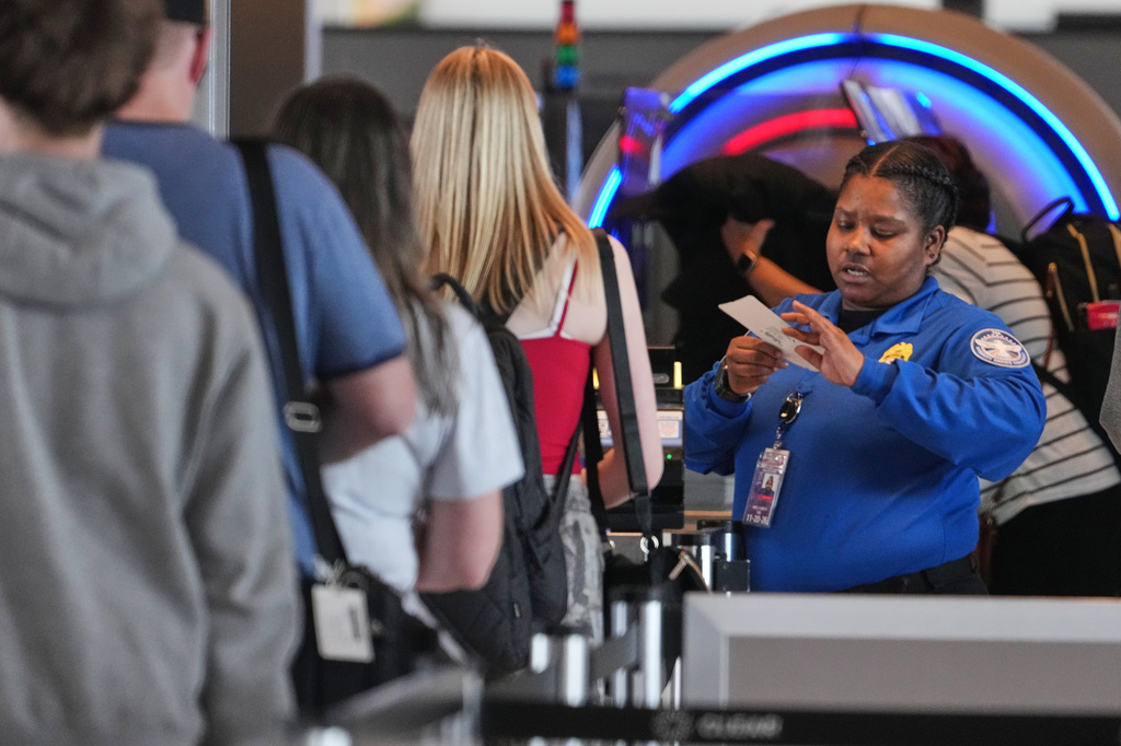 A TSA worker checks passengers at Greater Pittsburgh International Airport in Imperial, Pa., Thursday, March 26, 2026. (AP Photo/Gene J. Puskar)
