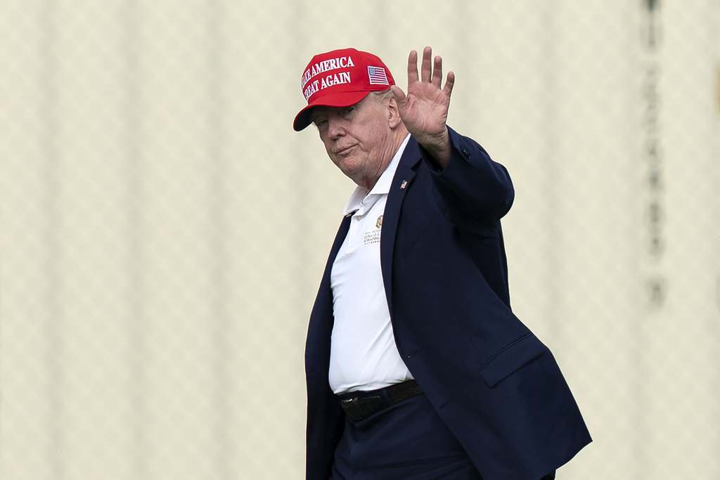 President Donald Trump waves to the media as he walks from Marine One to his limousine upon his arrival at the Ellipse just outside of the White House, Sunday, Aug. 16, 2026, in Washington. (AP Photo/Jose Luis Magana)