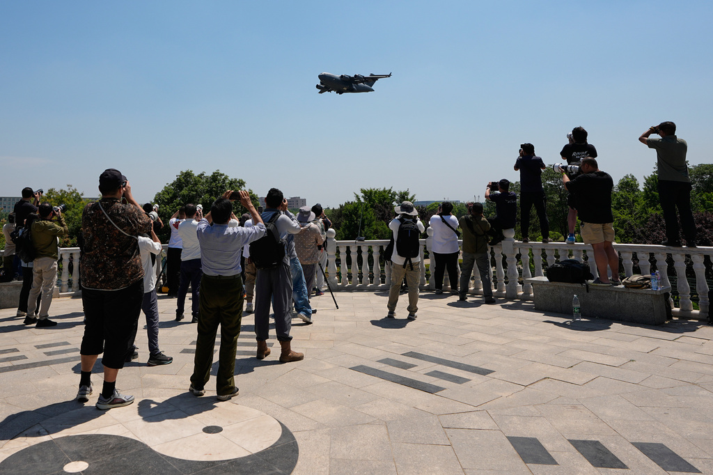 FILE - People gather at a viewing platform of a public park film a U.S. Air Force Boeing C-17 Globemaster III transport aircraft as its arrives at the Beijing International Capital Airport ahead of U.S. President Donald Trump's visit in Beijing, Monday, May 11, 2026. (AP Photo/Andy Wong, File)
