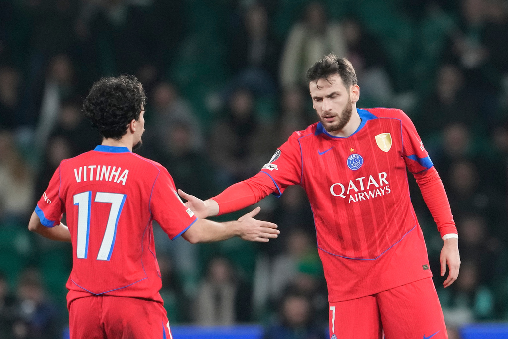 PSG's Khvicha Kvaratskhelia, right, celebrates after scoring his side's first goal with Vitinha during the Champions League opening phase soccer match between Sporting CP and Paris Saint-Germain, in Lisbon, Tuesday, Jan. 20, 2026. (AP Photo/Armando Franca)
