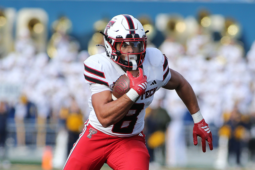 Texas Tech running back Cameron Dickey (8) runs against West Virginia during the first half of an NCAA college football game Saturday, Nov. 29, 2025, in Morgantown, W.Va. (AP Photo/Kathleen Batten)