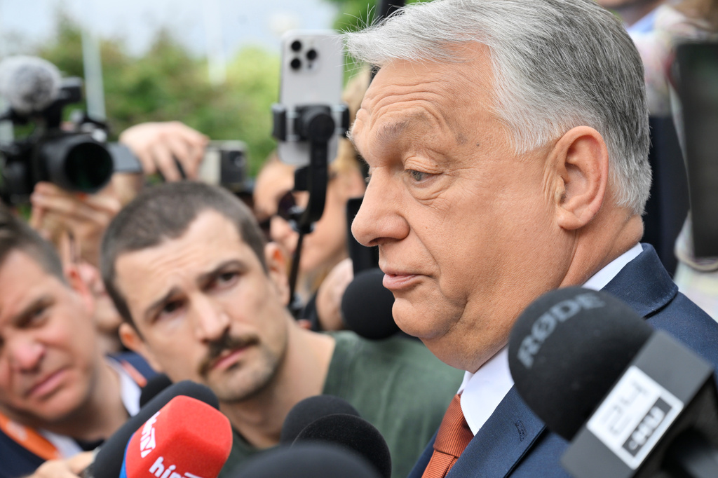 Fidesz party head and former prime minister Viktor Orban, center, speaks to the press as he arrives at the opposition Fidesz party's working congress meeting, in Budapest, Hungary, Saturday, June 13, 2026. (Zoltan Mathe/MTI via AP)