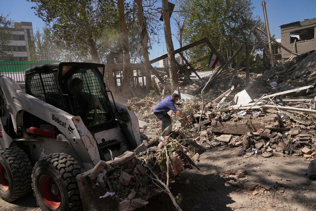 Workers remove debris at Tehran's Sharif University of Technology complex that Iranian authorities say was hit early Monday by a U.S.-Israeli strike, in Tehran, Iran, Monday, April 6, 2026. (AP Photo/Francisco Seco)