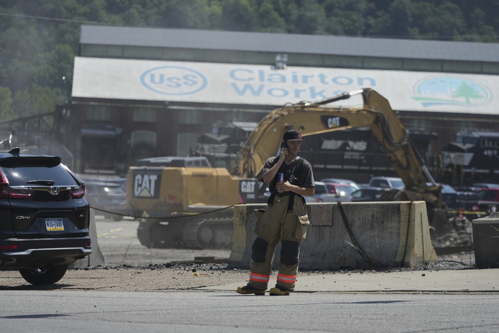 An emergency crew is seen after an explosion at the Clairton Coke Works, a U.S. Steel coking plant, Monday, Aug 11, 2025, in Clairton, Penn. (AP Photo/Gene Puskar)