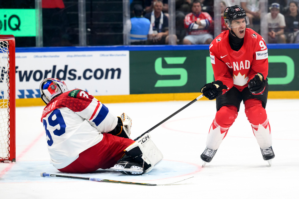 Canada's John Tavares, right, celebrates scoring during the Group B preliminary round between the Czech Republic and Canada at the men's ice hockey world championship in Fribourg, Switzerland, Tuesday, May 26, 2026. (Laurent Gillieron/Keystone via AP)