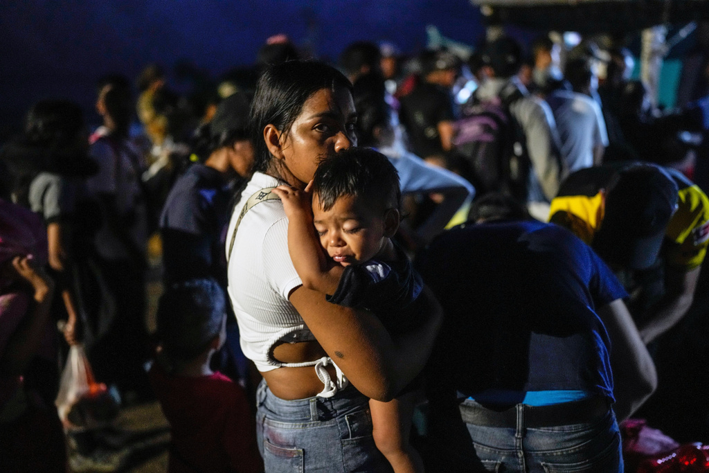 Venezuelan migrant Luisleibis Navarro carries her son, as he waits to board a boat departing from Panama's Caribbean coastal village of Miramar to the border with Colombia, Feb. 27, 2025. (AP Photo/Matias Delacroix, File)