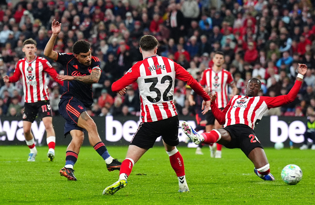 Nottingham Forest's Morgan Gibbs-White, left, scores their third goal of the game during the Premier League soccer match between Sunderland and Nottingham Forest, Friday, April 24, 2026, in Sunderland, England. (Owen Humphreys/PA via AP)