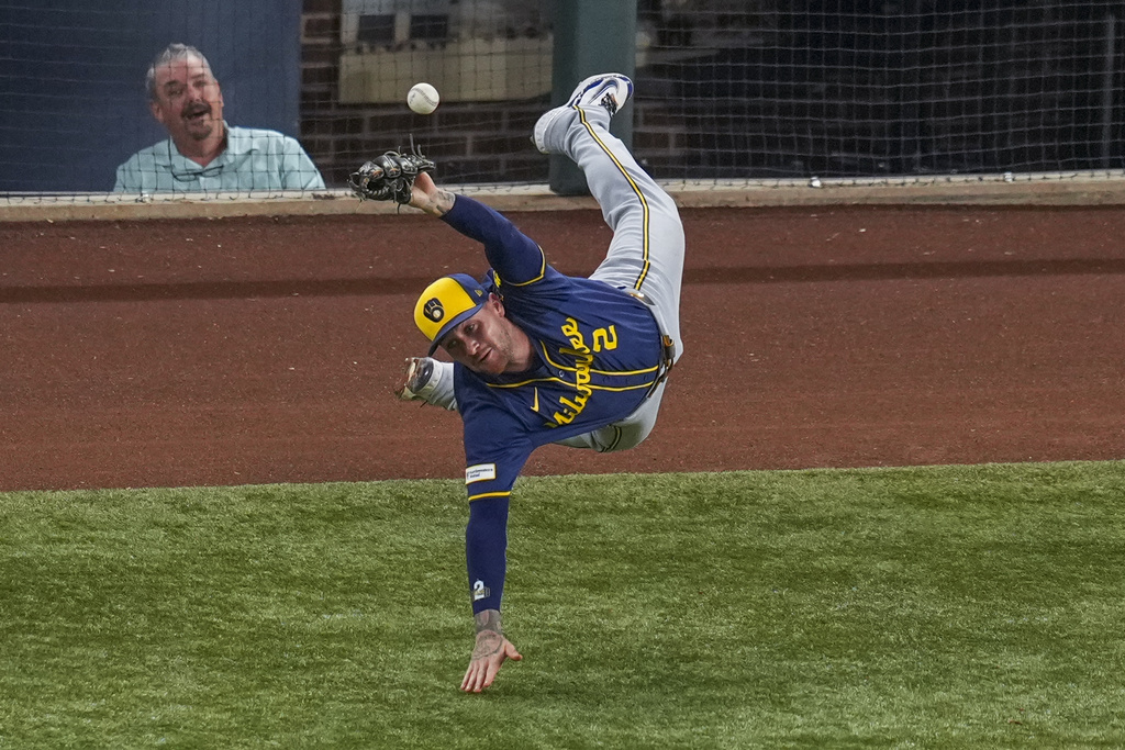 Milwaukee Brewers second baseman Brice Turang overruns a foul ball by Texas Rangers' Jake Burger during the fifth inning of a baseball game Monday, Sept. 8, 2025, in Arlington, Texas. (AP Photo/Julio Cortez)