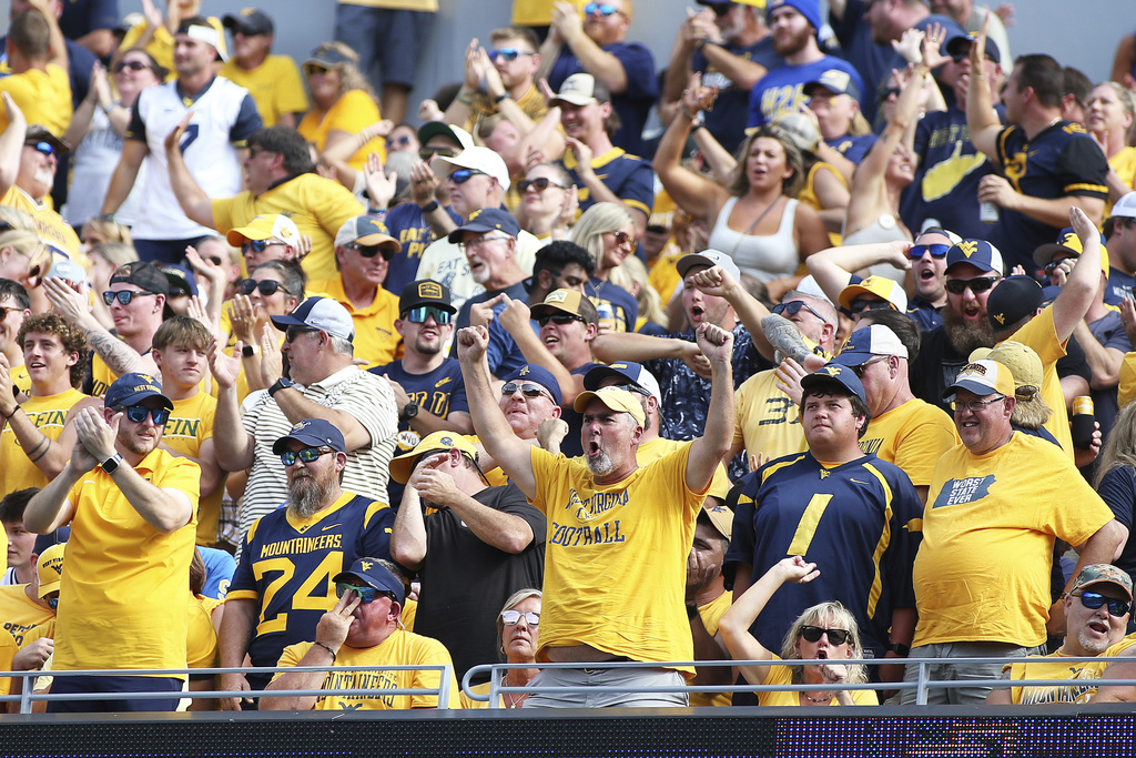 West Virginia fans react during the first half of an NCAA college football game against Pittsburgh Saturday, Sept. 13, 2025, in Morgantown, W.Va. (AP Photo/Kathleen Batten)