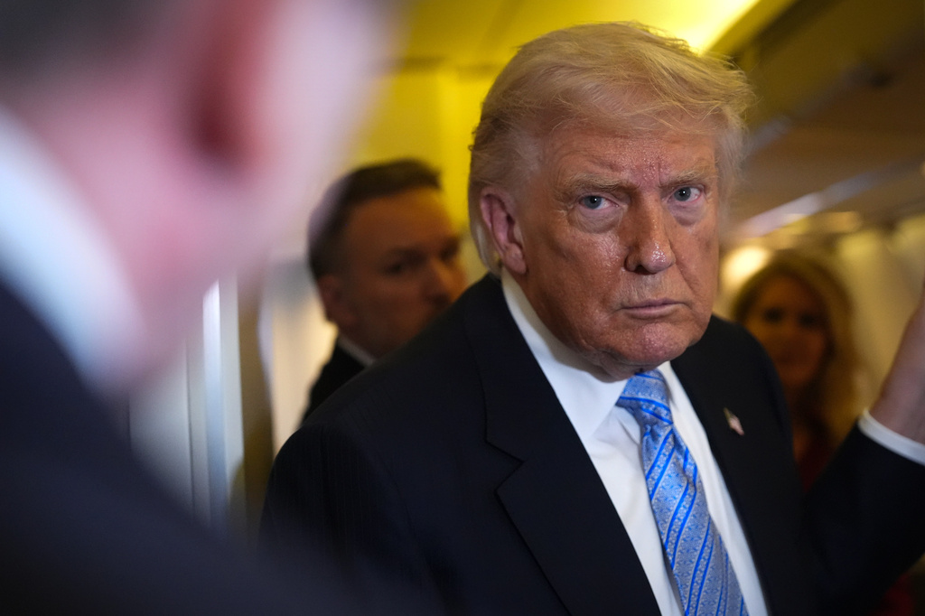 President Donald Trump speaks to reporters aboard Air Force One, Friday, May 15, 2026, as he returns from a trip to Beijing, China. (AP Photo/Mark Schiefelbein)